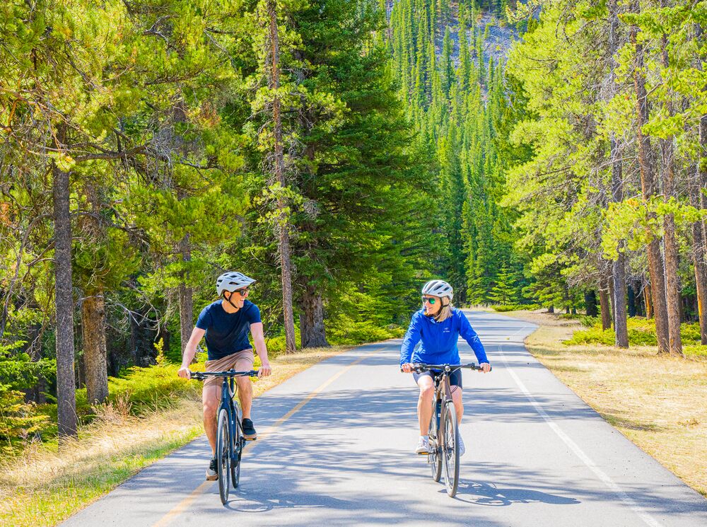 Two people biking the golf course loop on a summer day in Banff National Park