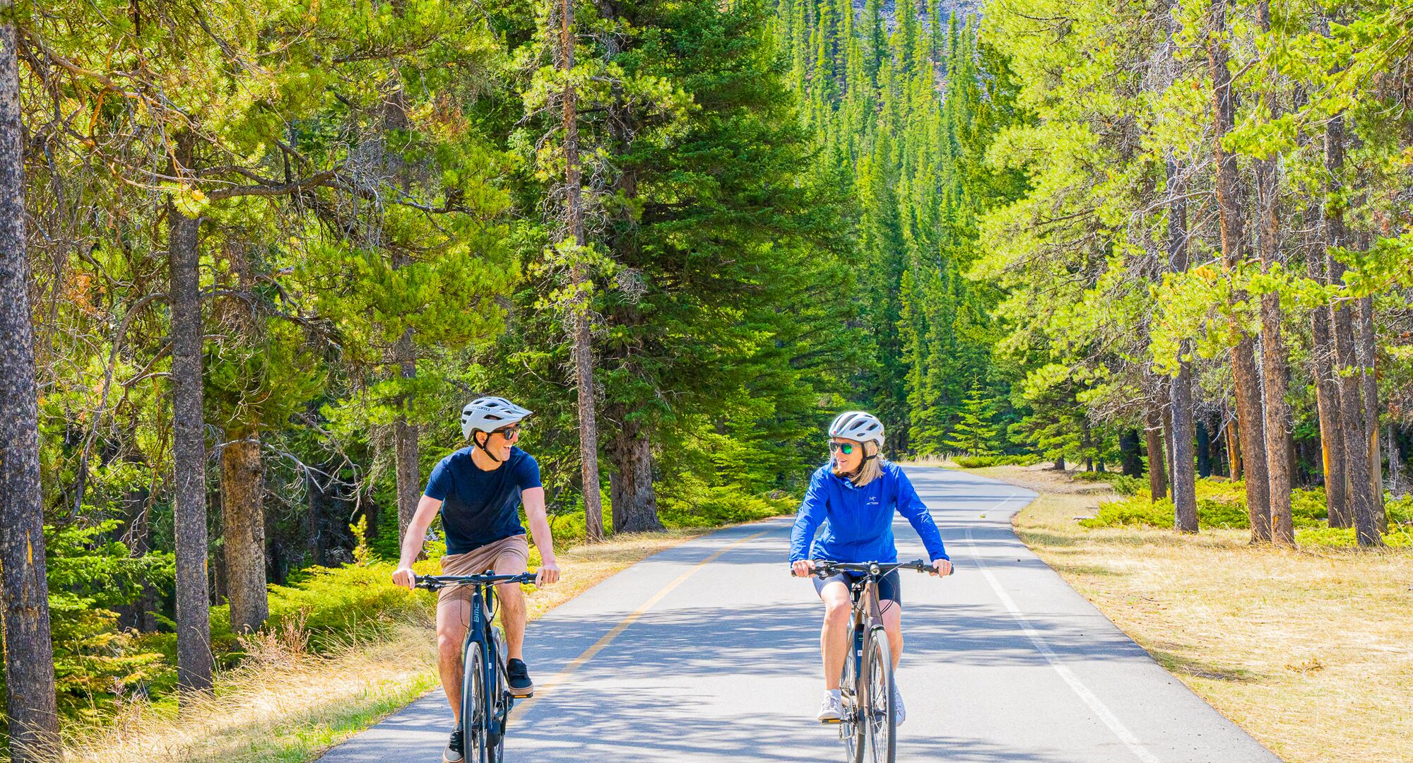 Two people biking the golf course loop on a summer day in Banff National Park