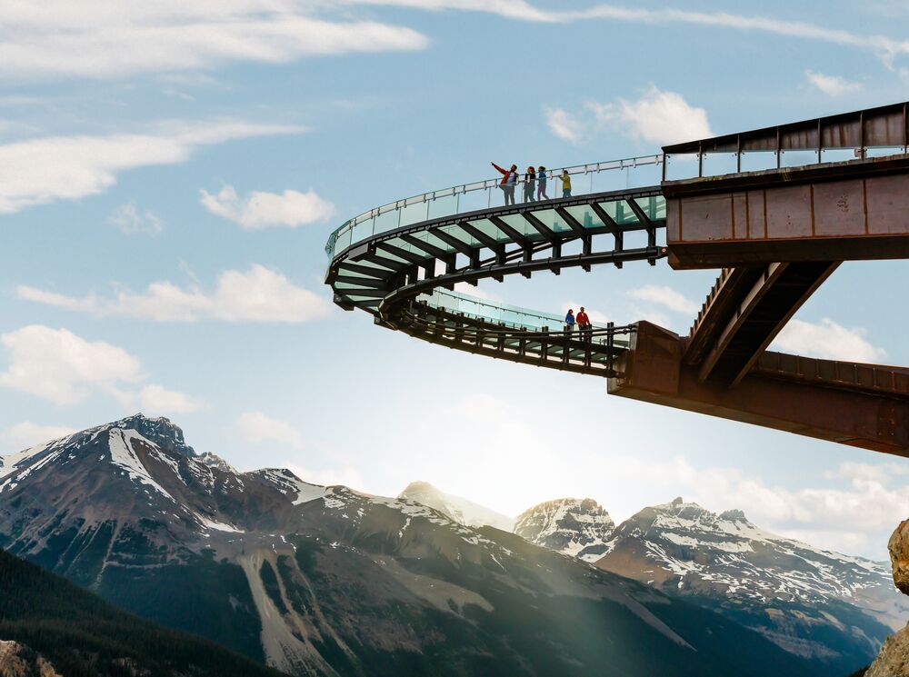 People standing on the Glacier Skywalk taking in the views of the surrounding mountains