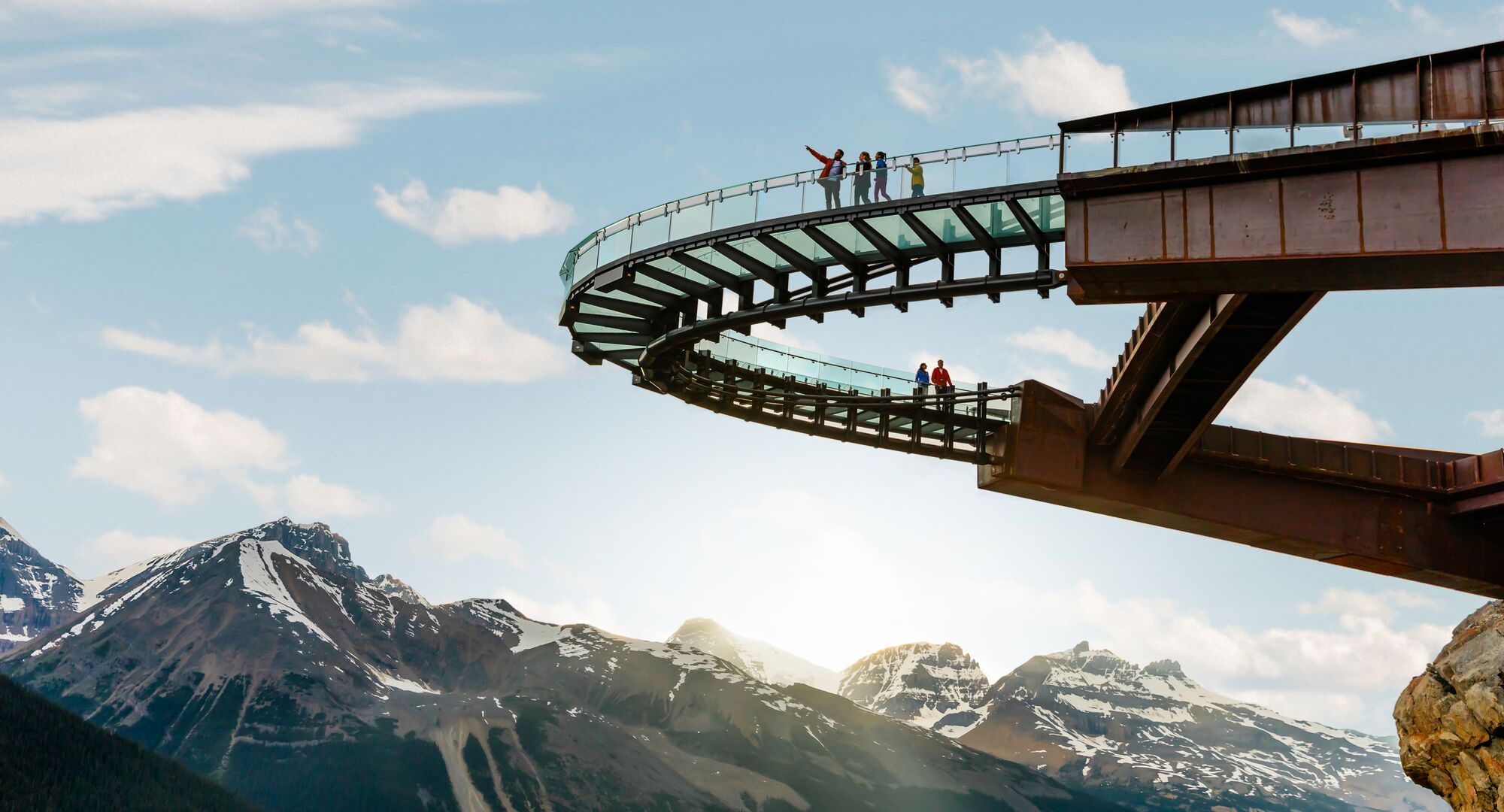 People standing on the Glacier Skywalk taking in the views of the surrounding mountains