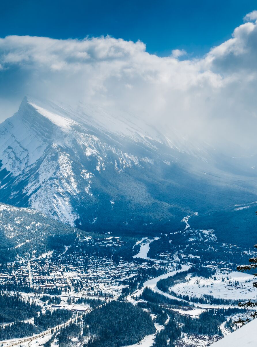A snowy Moount Rundle with the Banff townsite below it as seen from Mt. Norquay in Banff National Park.