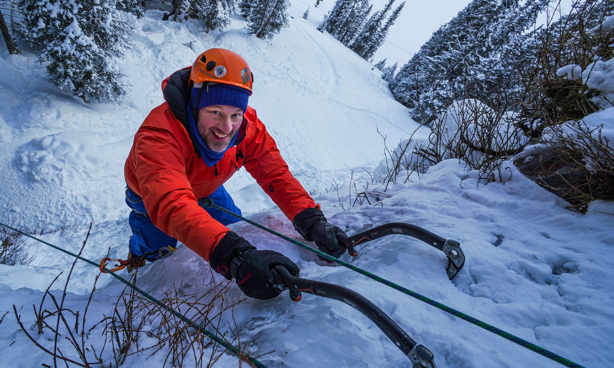 A man ice climbs in Lake Louise during the winter.