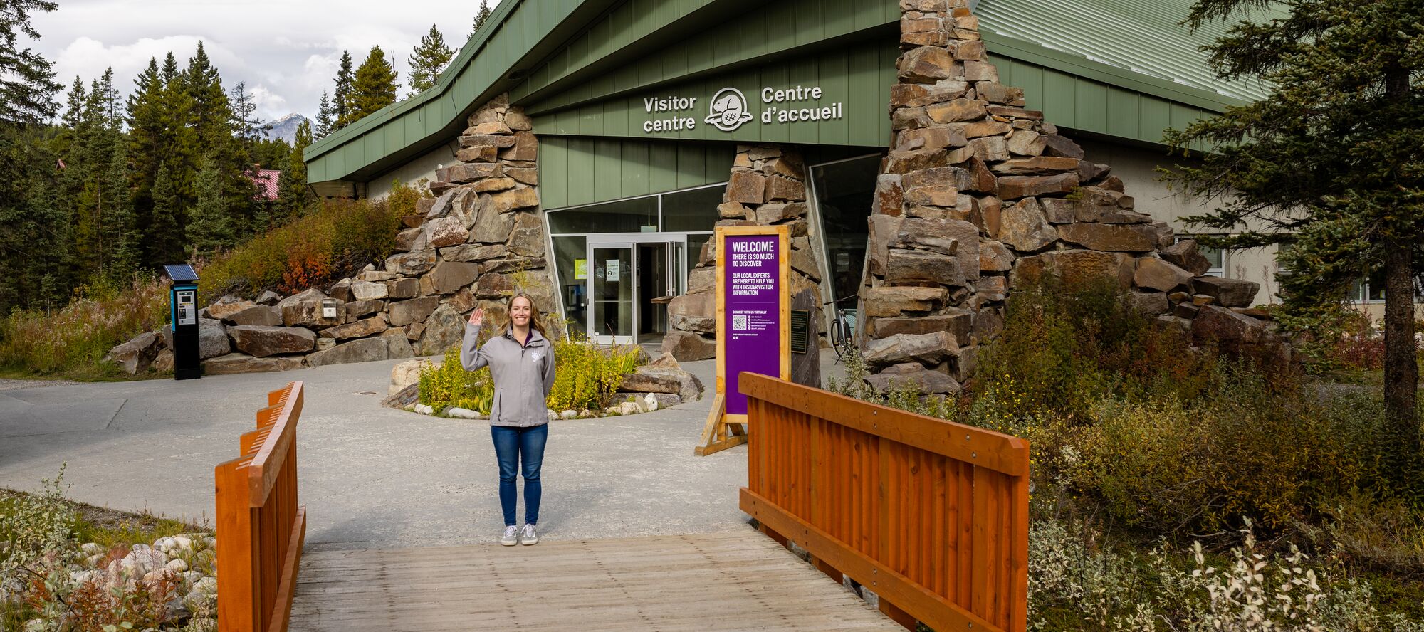 A visitor services team member with Banff Lake Louise Tourism greets guests at the Lake Louise Visitor Centre