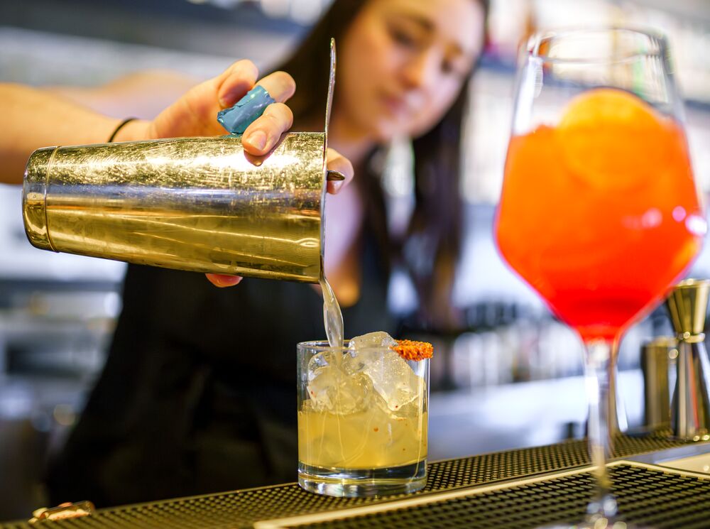 A bartender pours out a mocktail at Earl's in Banff National Park