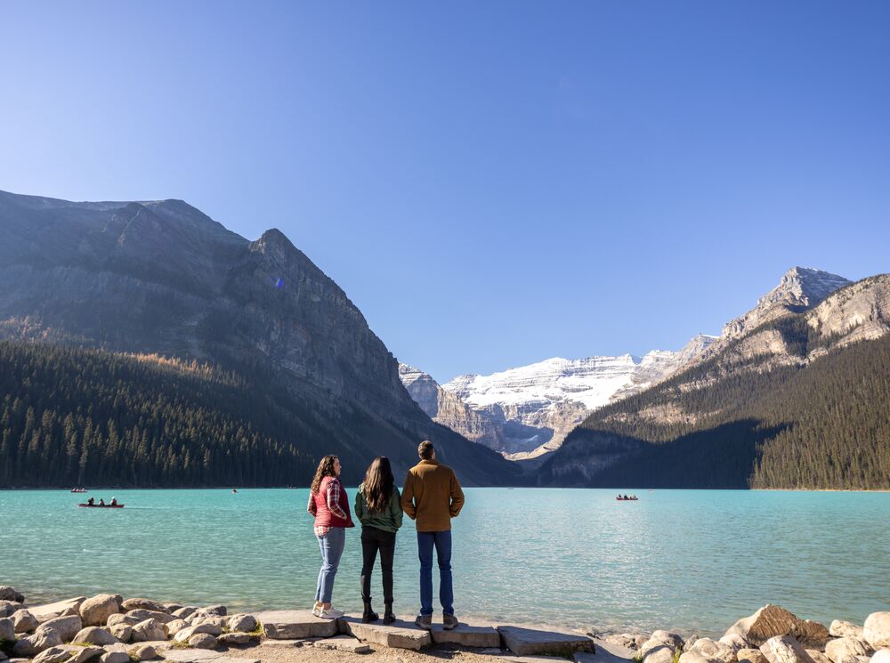 Three people visiting Lake Louise, one of the best things to do in Banff National Park in June