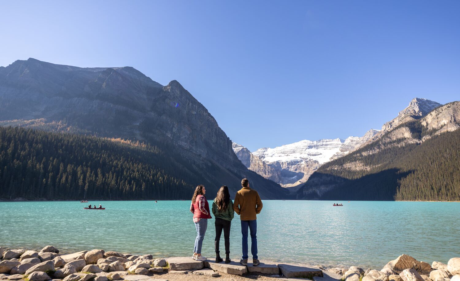 Three people visiting Lake Louise, one of the best things to do in Banff National Park in June