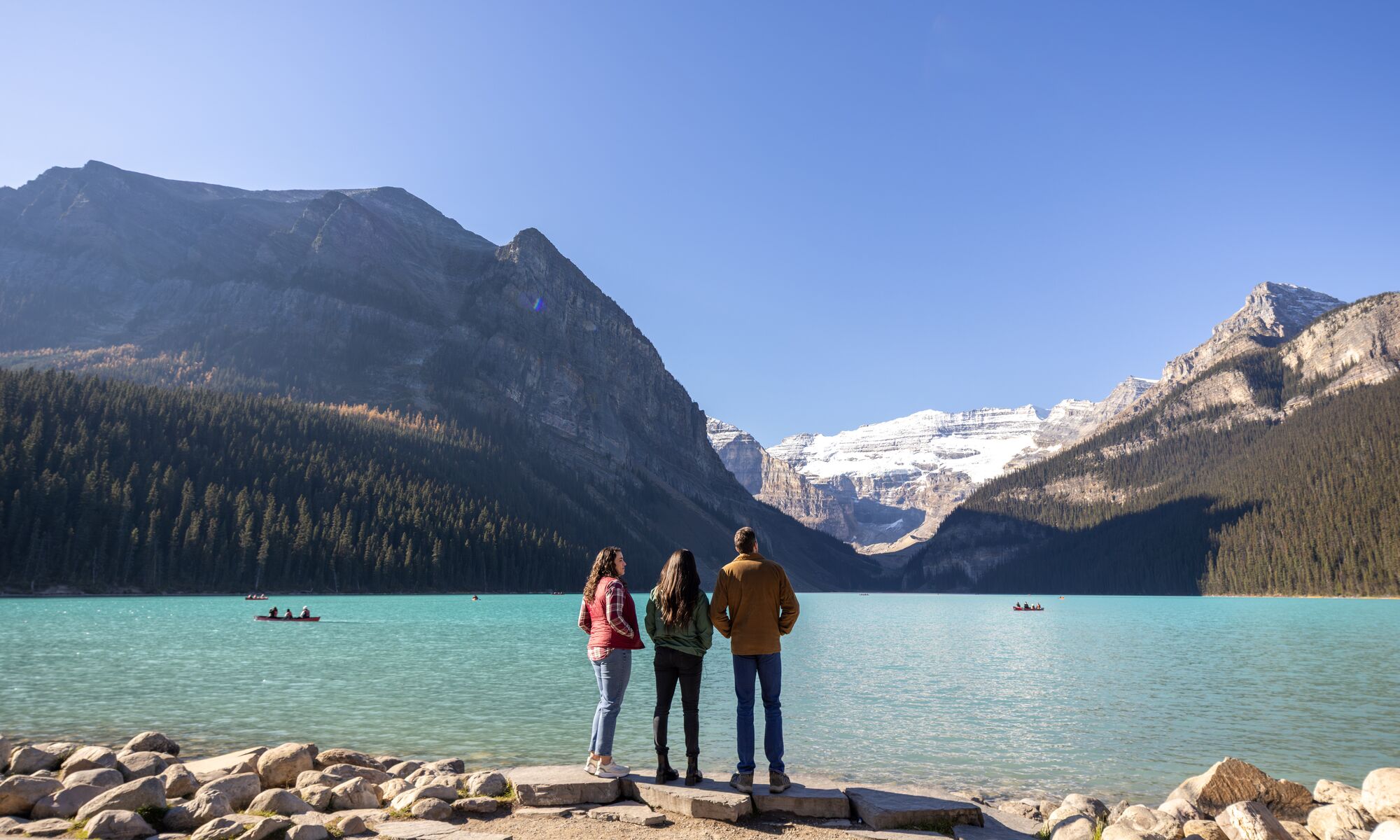 Three people visiting Lake Louise, one of the best things to do in Banff National Park in June