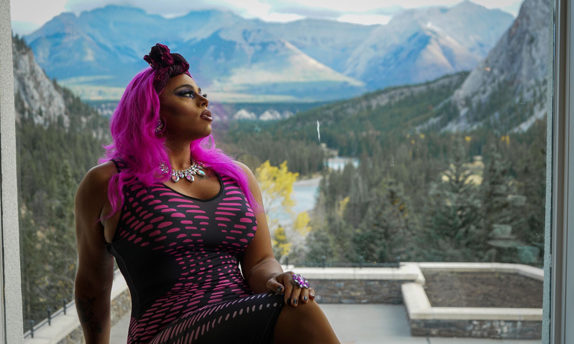 A drag performer sits in a window in the Vermilion Room at the Banff Springs Hotel in Banff National Park.