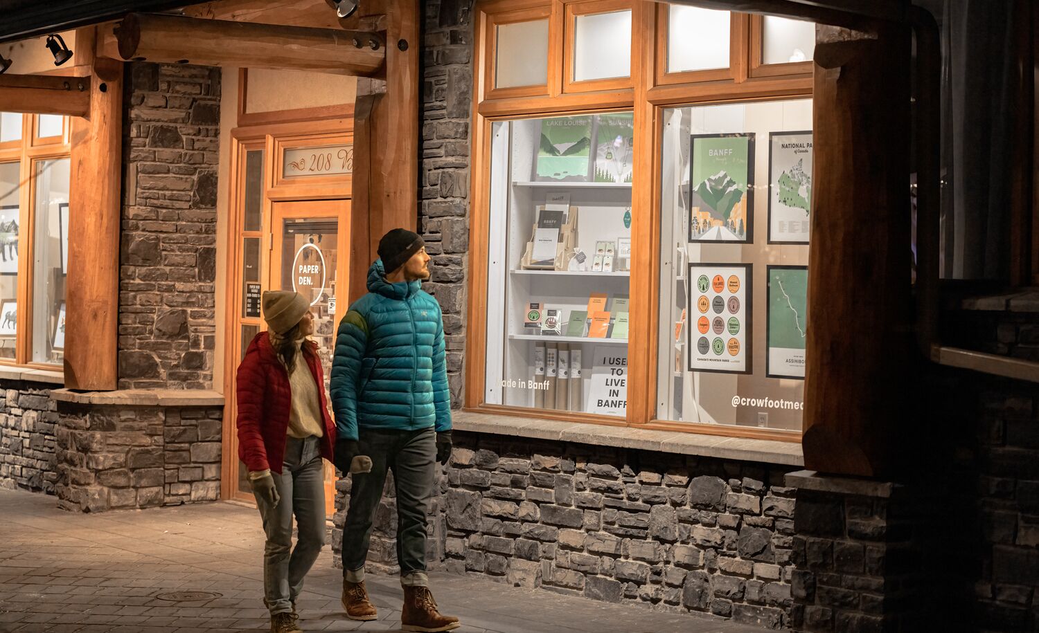 A couple walks on Bear Street in Banff.