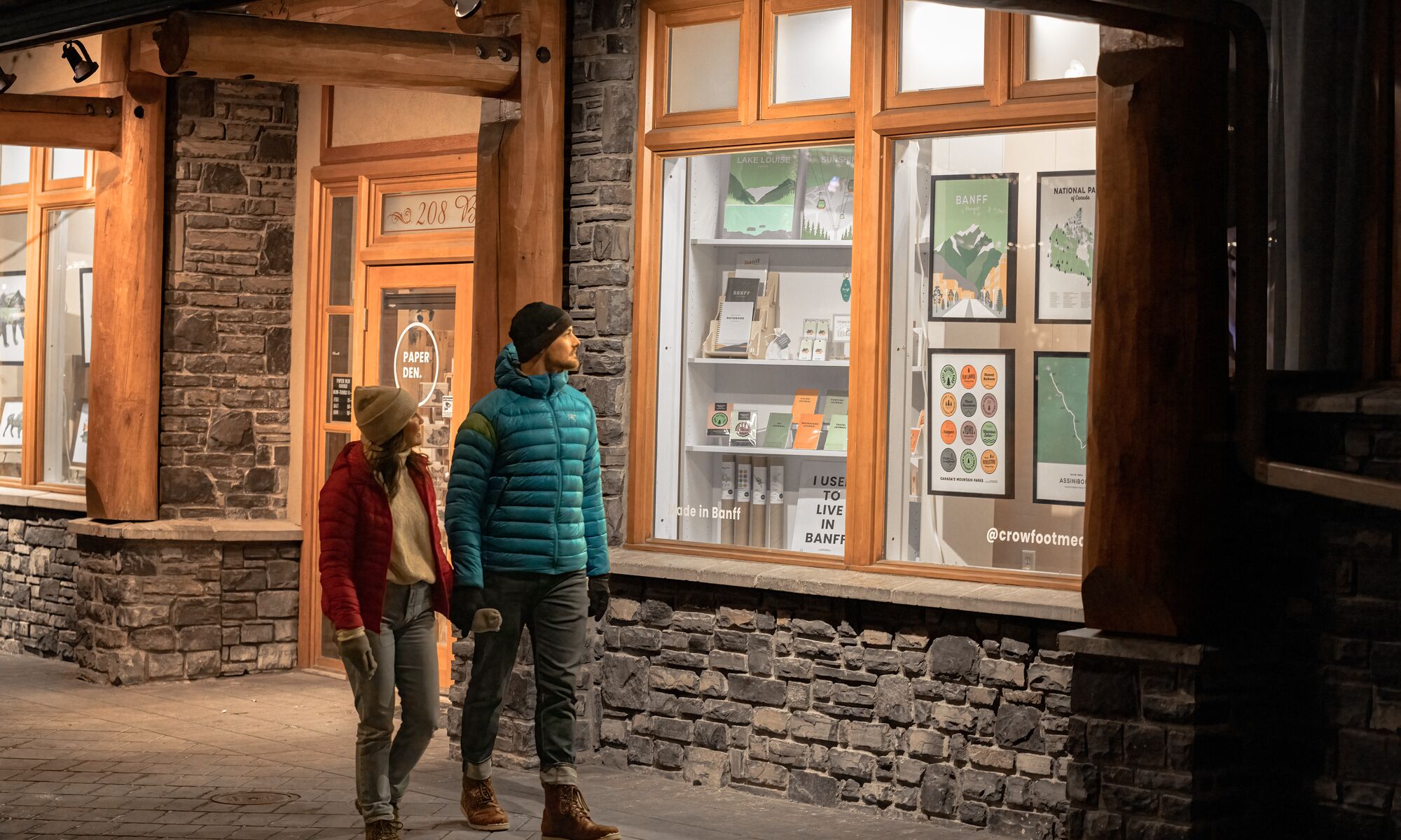 A couple walks on Bear Street in Banff.