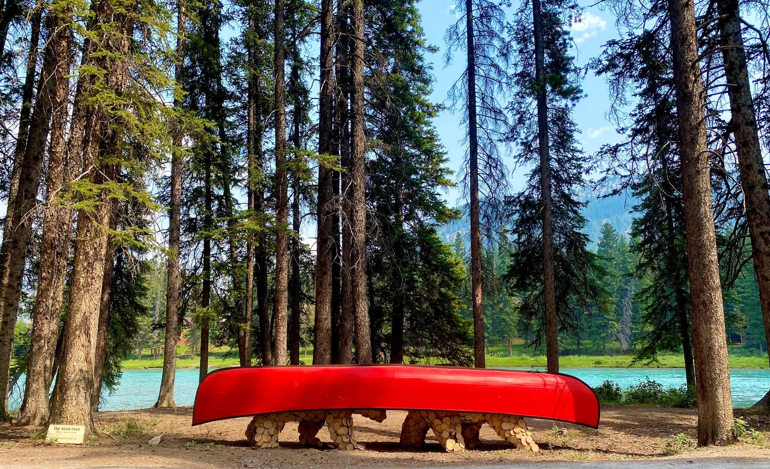A statue of two bears carrying a red canoe on their back during the Art in Nature Trail in Banff.