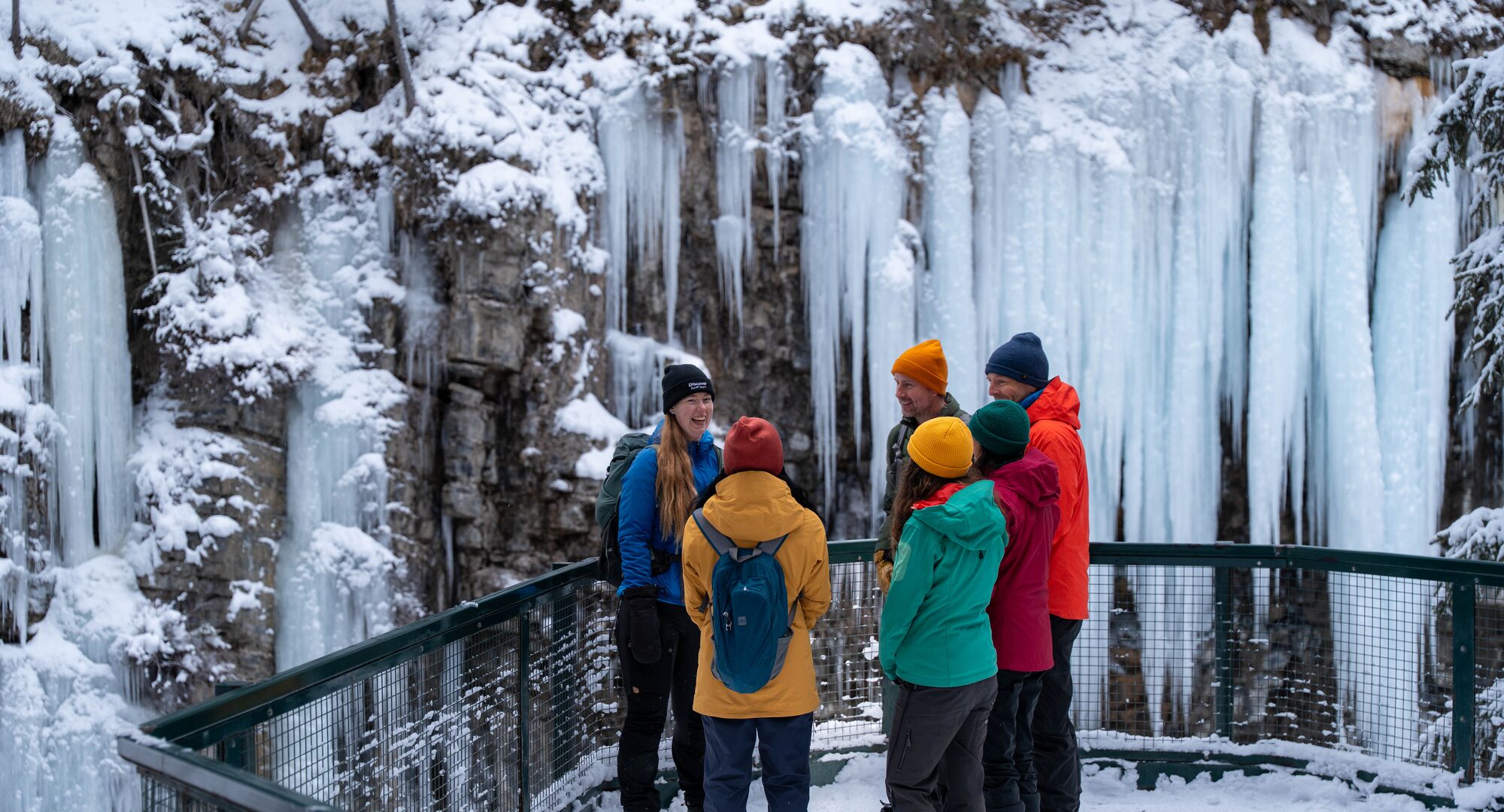A group of people on a guided ice walk in Johnston Canyon in the winter in Banff National Park