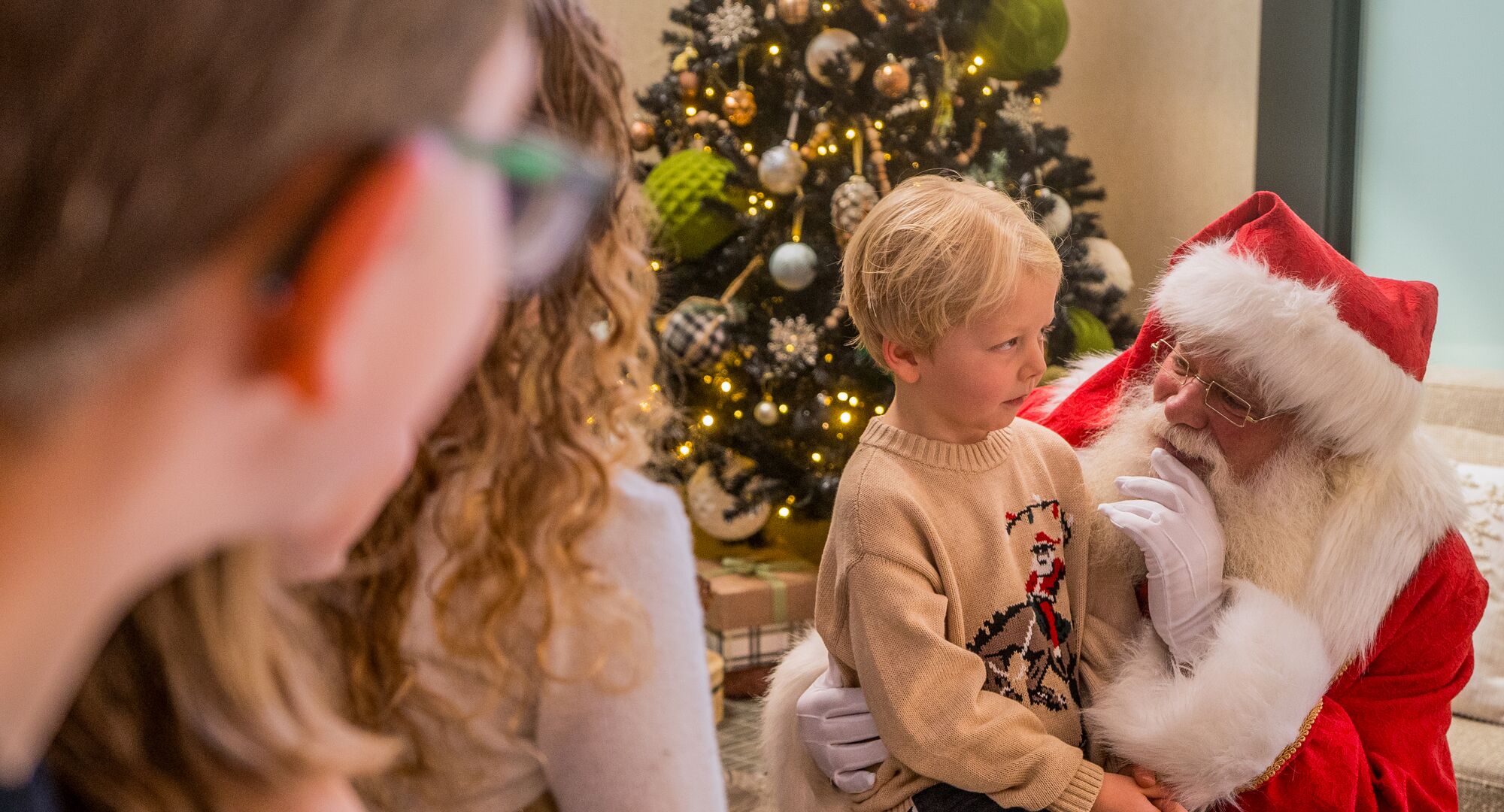 Santa visiting with Children at The Kenrick Hotel