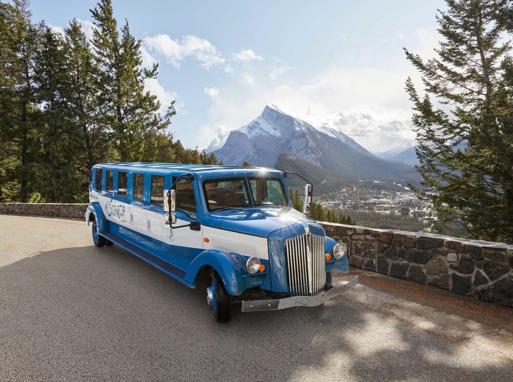 Pursuits Open Top Touring bus sits on the Mt. Norquay viewpoint in Banff National Park
