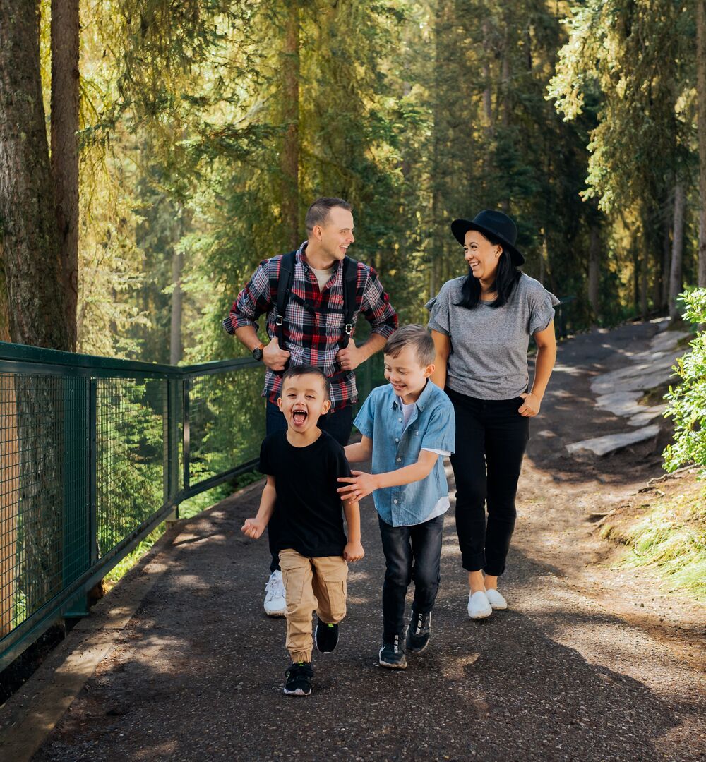 Family of four having fun on the Johnston Canyon hiking trail