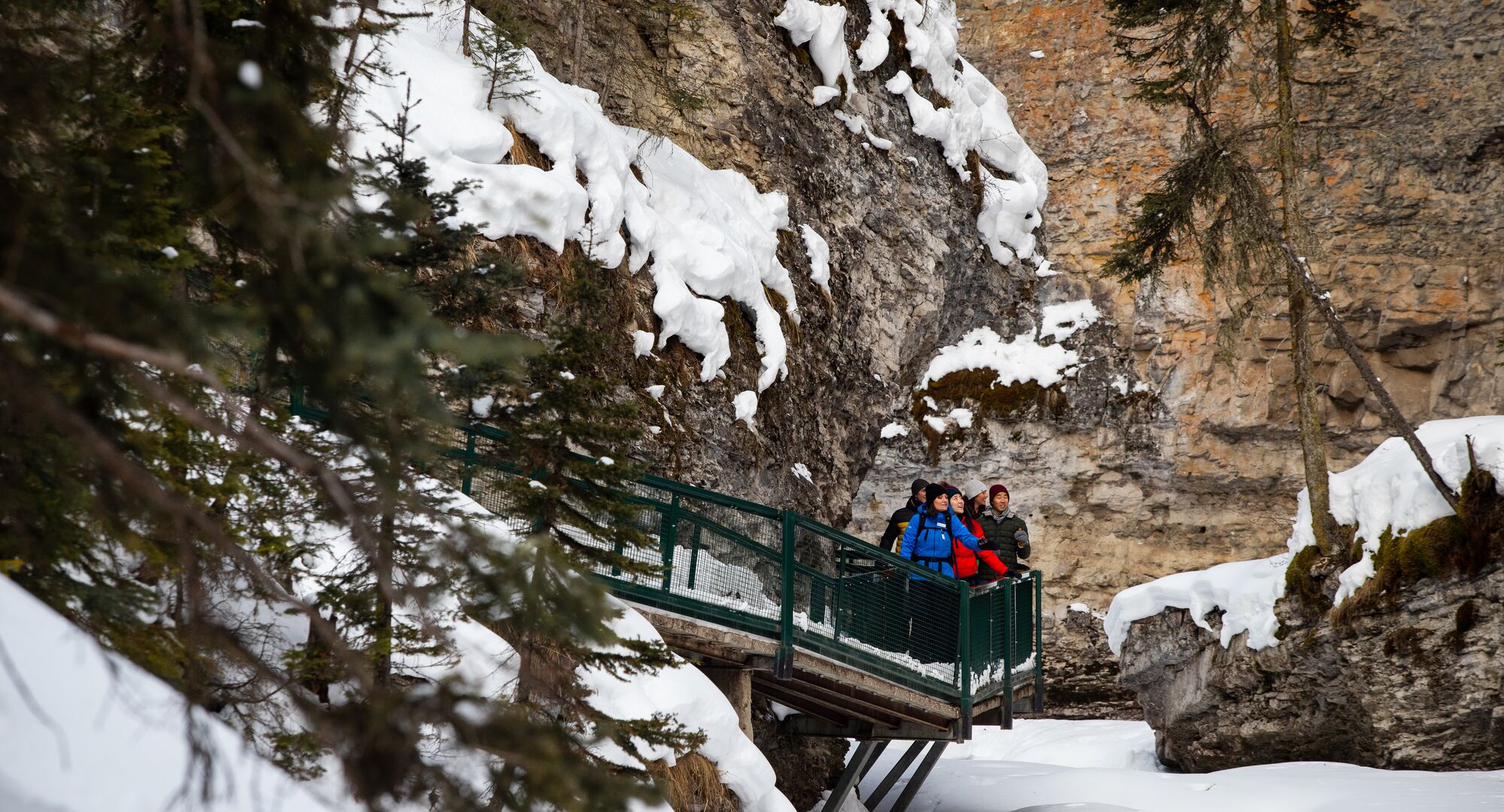 Group of people on a winter ice walk tour at Johnston Canyon in Banff National Park