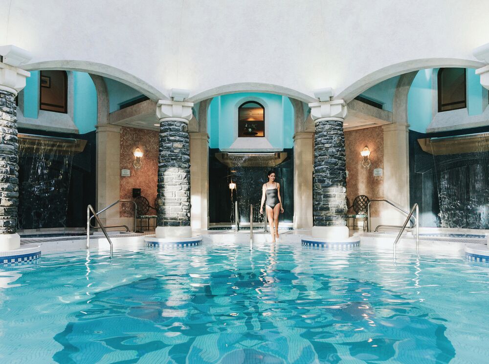 A person entering the pools at Fairmont Spa at the Fairmont Banff Springs Hotel.