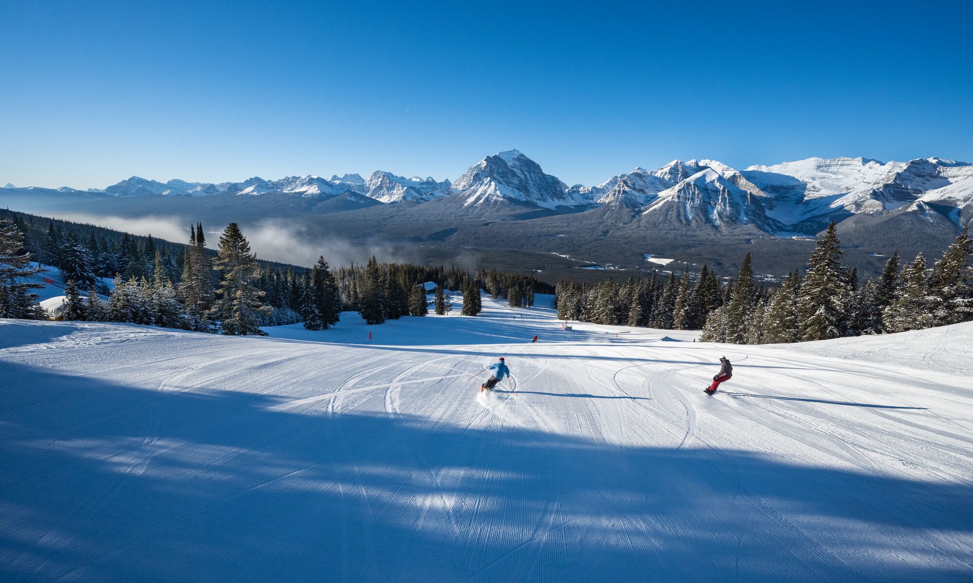 Snowboarders and skiers rip down the Lake Louise Ski Resort in Banff National Park.