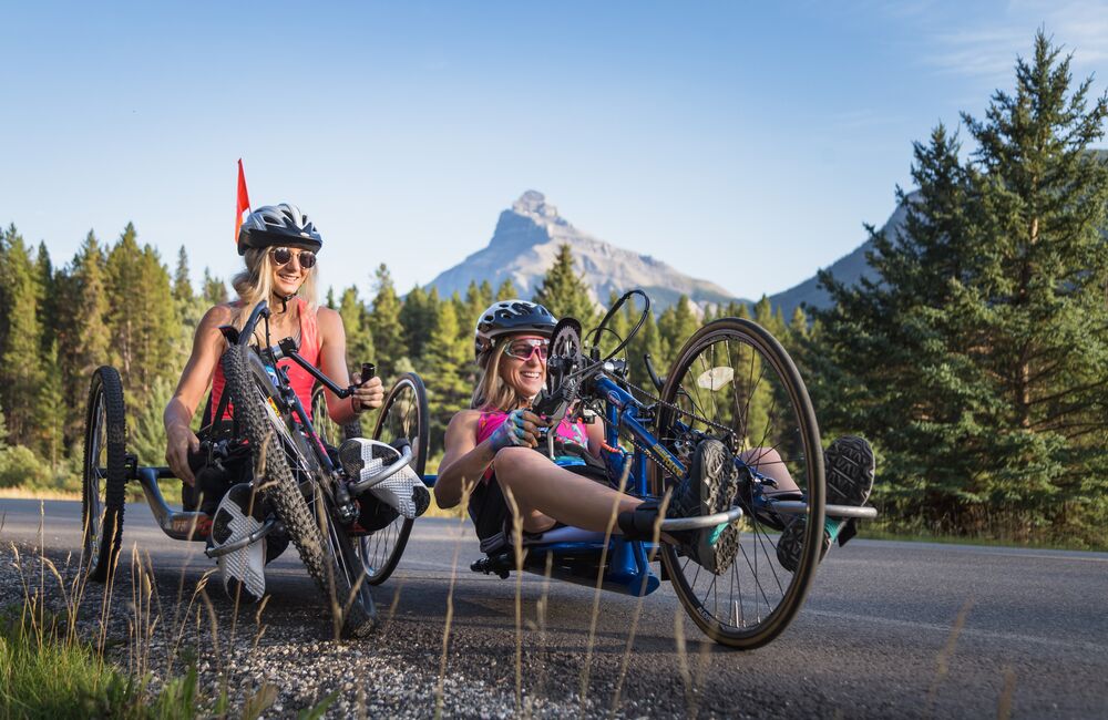 Two bike riders ride on the Bow Valley Parkway in Banff National Park.