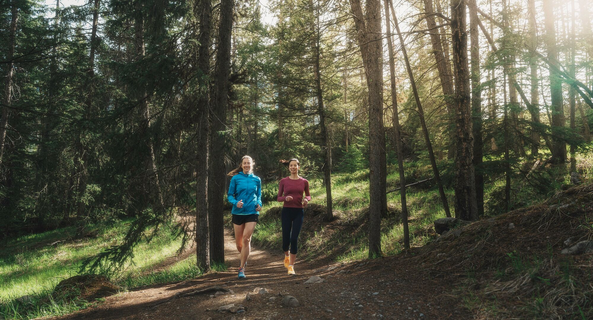 Two people running the Spray Loop in Banff National Park