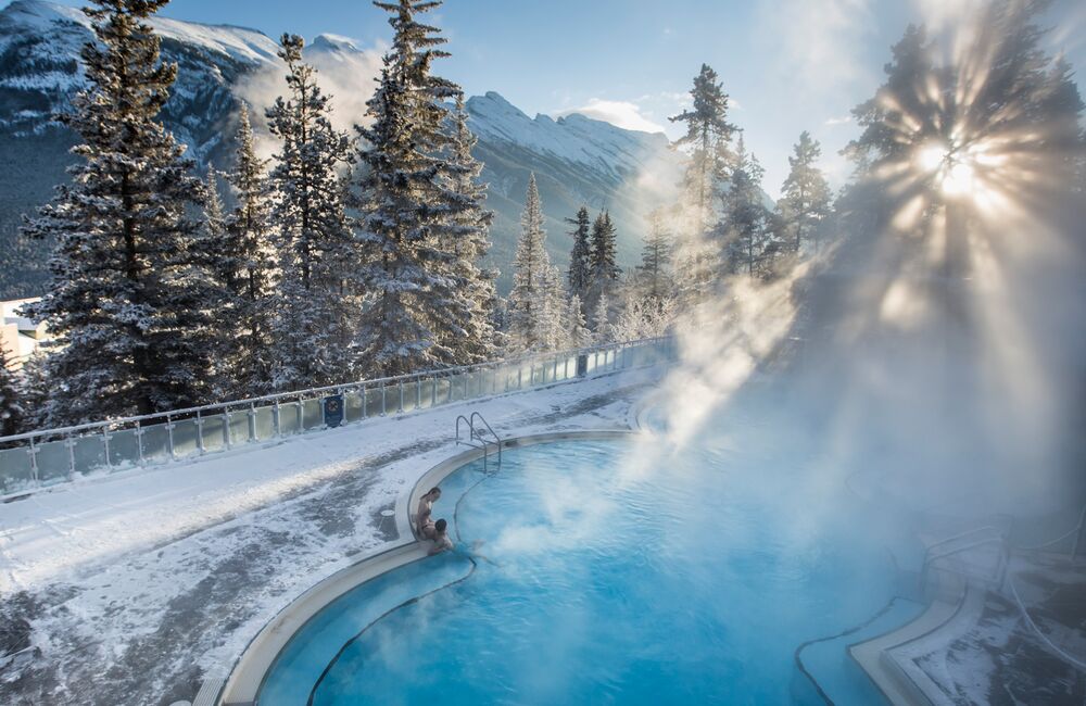 A couple sits in the Upper Hot Springs in Banff National Park on a frosty winter day