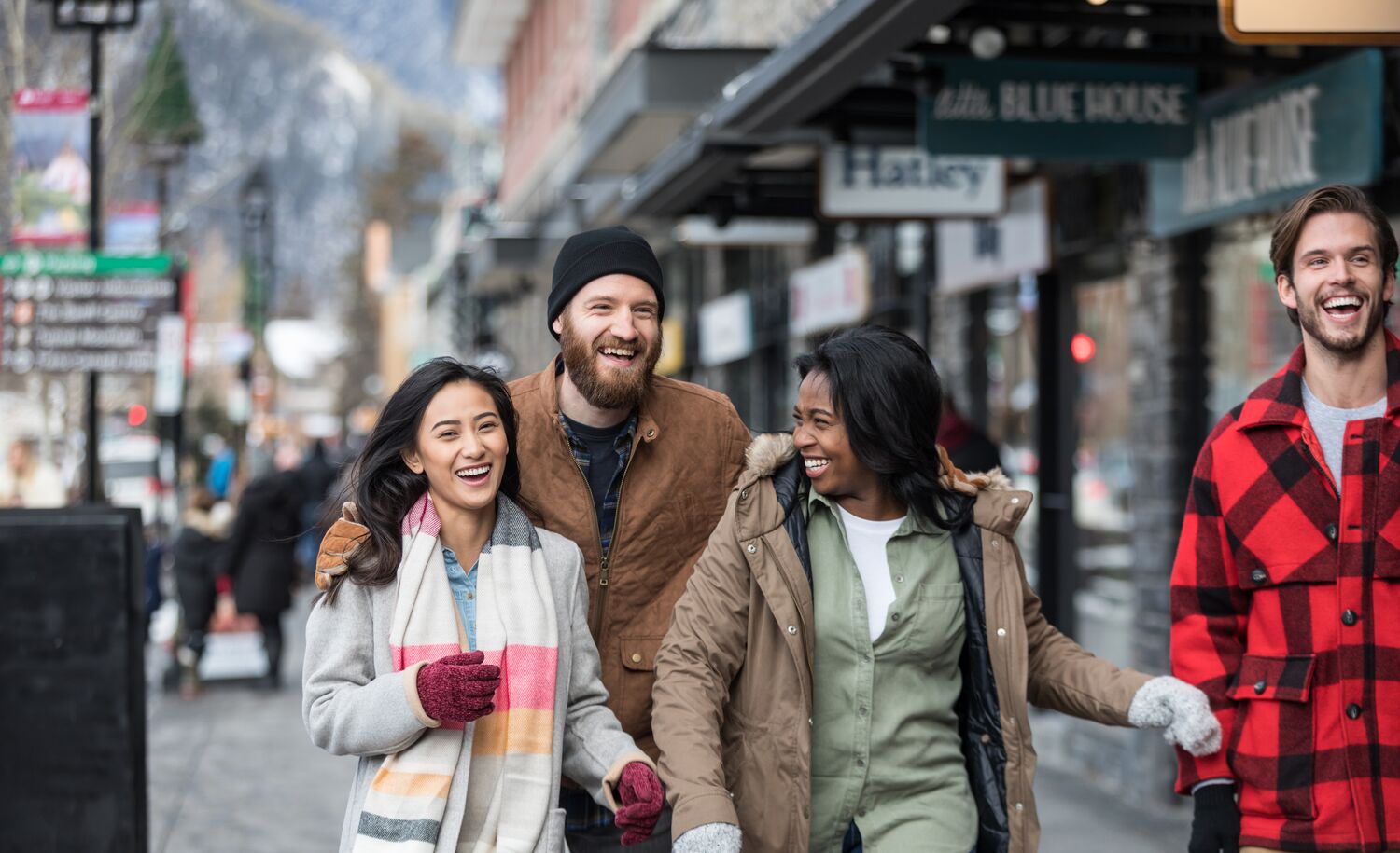 A group of friends happily walking along Banff Avenue to go shopping 